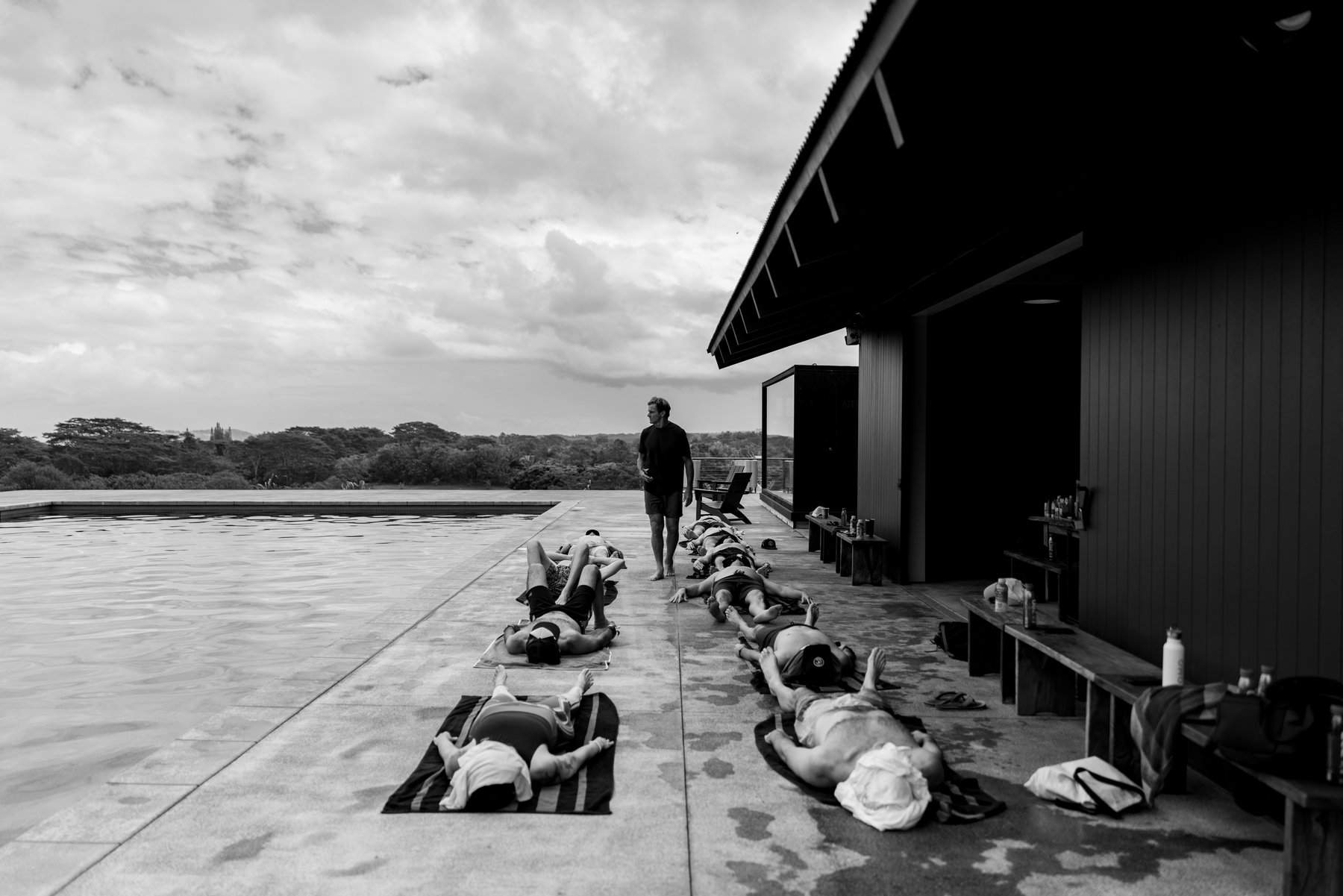 Laird leading a breathwork and recovery session on the pool deck